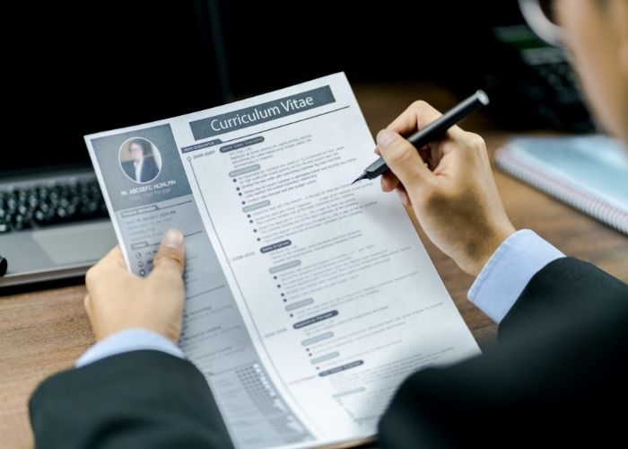 E3839785 01f1 43c1 Bf27 22ae3f241856 Employer Looking at CV and Job Application