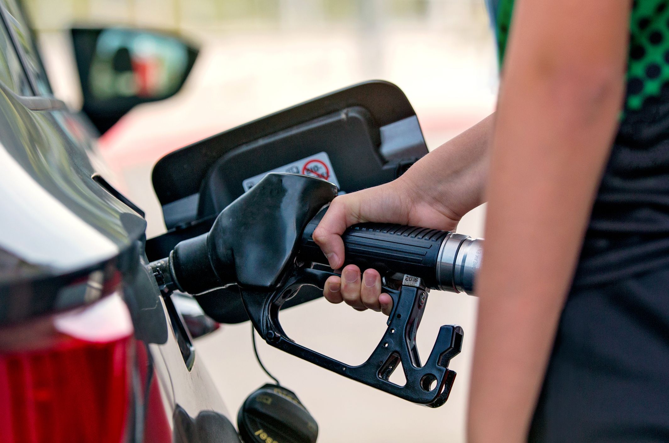 Close up of a Hand Pouring Fuel Into a Car Royalty Free Image 1584165892